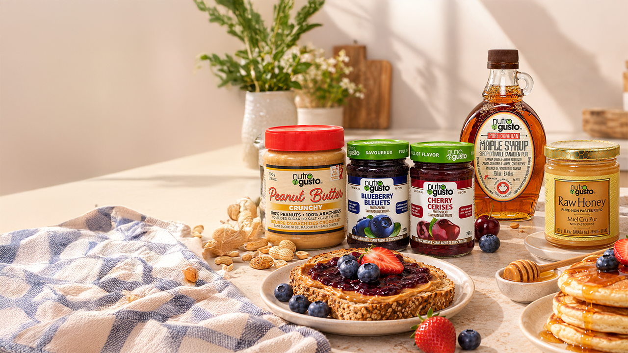 NutroGusto peanut butter, fruit jams, maple syrup and honey on a breakfast table